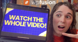 a person with long hair and a surprised expression points to a tablet screen displaying the text watch the whole video! the wpfusion logo is visible above, hinting at seamless integration with presto player. background includes string lights and a poster.