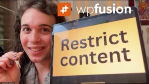 a person smiling, holding a key, stands beside a tablet showing restrict content, proudly featuring the wpfusion logo at the top. perfect for seamlessly managing wordpress content and enhancing seo keywords with ease.
