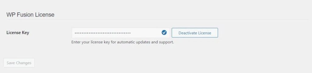 screenshot of wp fusion license page with a text box containing a hidden license key represented by dots. the options deactivate license in blue and save changes in gray are visible, showcasing an essential step by step guide for seamless wordpress integration.